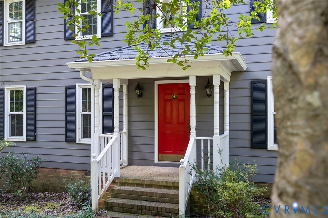 Property entrance with covered porch