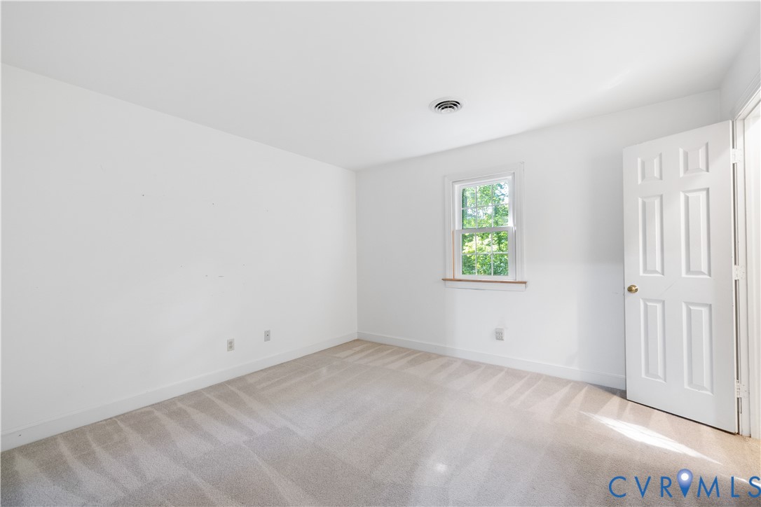 8939 Cardiff Road North Chesterfield, VA 23236 - Photo 30 of 45 Empty room featuring light carpet and baseboards