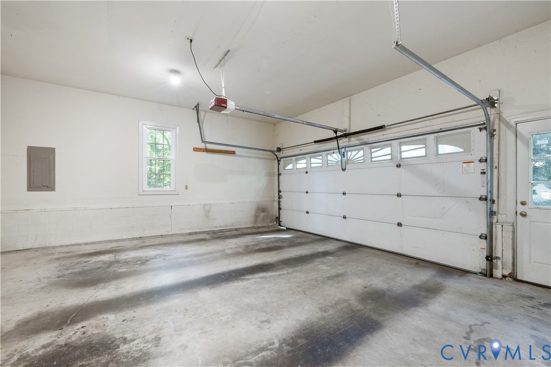8939 Cardiff Road North Chesterfield, VA 23236 - Photo 38 of 45 Garage with electric panel and a garage door opene