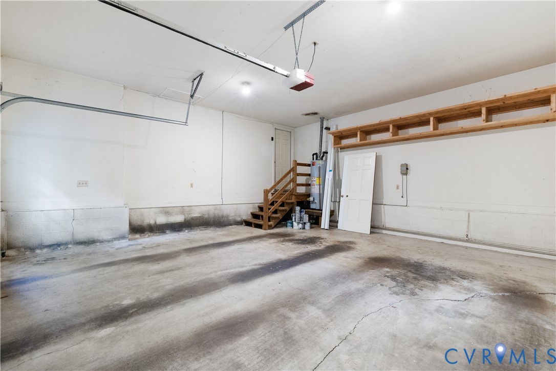 8939 Cardiff Road North Chesterfield, VA 23236 - Photo 39 of 45 Garage with a garage door opener and gas water hea