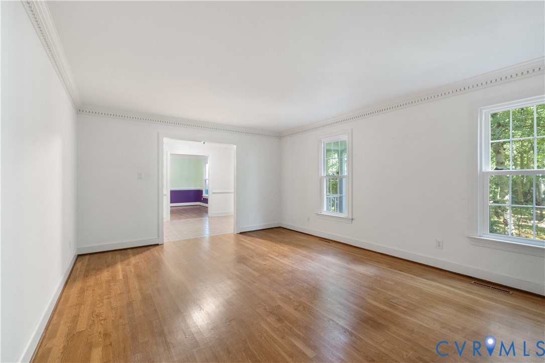 Unfurnished room featuring crown molding and light