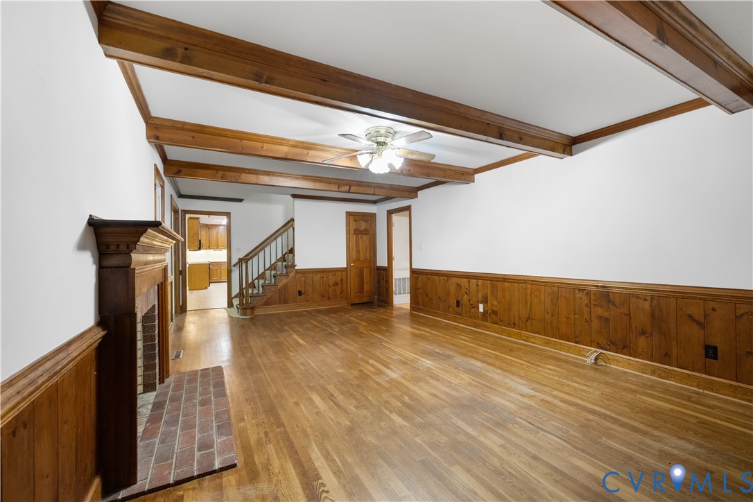 8939 Cardiff Road North Chesterfield, VA 23236 - Photo 9 of 45 Unfurnished living room with wainscoting, wooden w