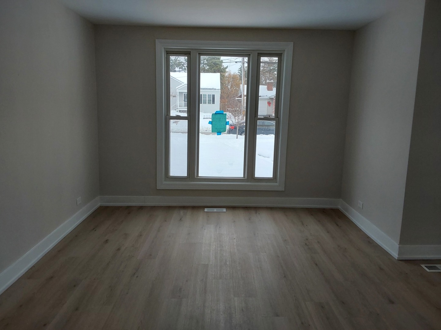722 East Indiana Street Wheaton, IL 60187 - Photo 4 of 16 an empty room with wooden floor and windows
