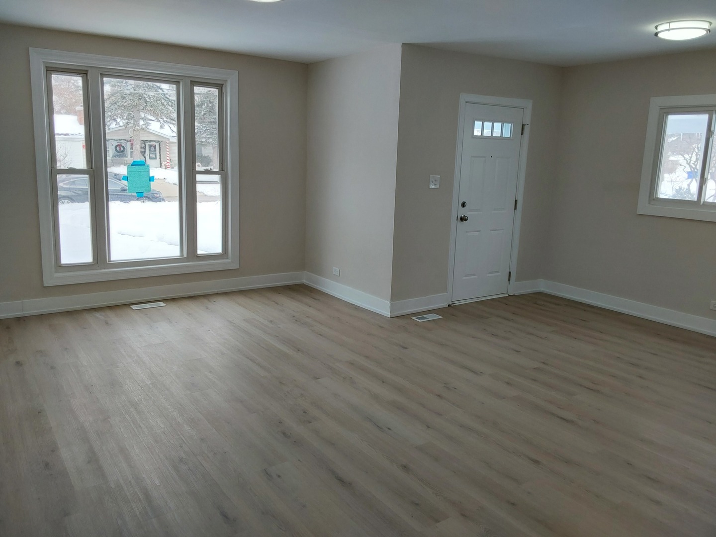722 East Indiana Street Wheaton, IL 60187 - Photo 5 of 16 an empty room with wooden floor and windows