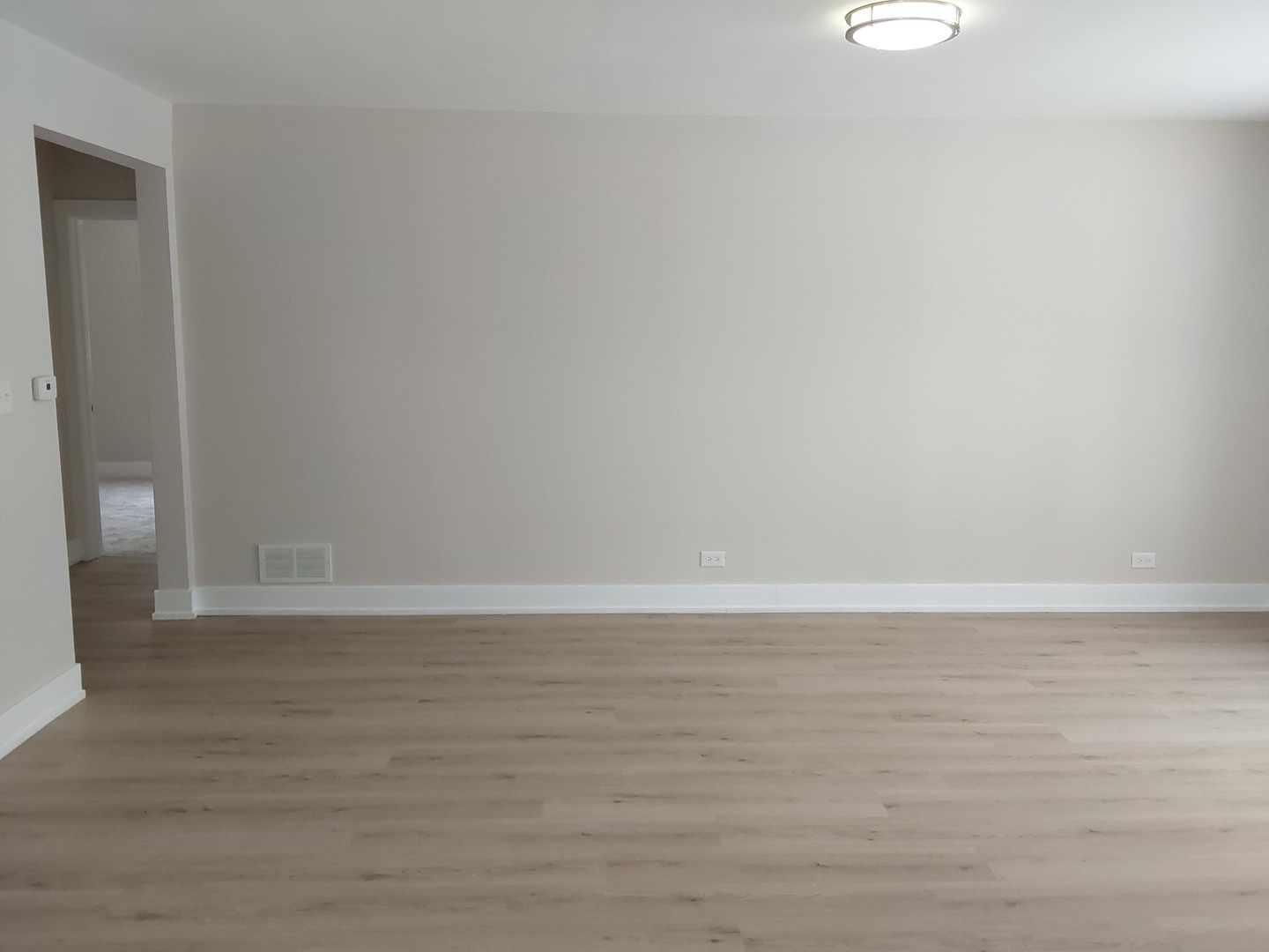 722 East Indiana Street Wheaton, IL 60187 - Photo 6 of 16 a view of an empty room with wooden floor and a window