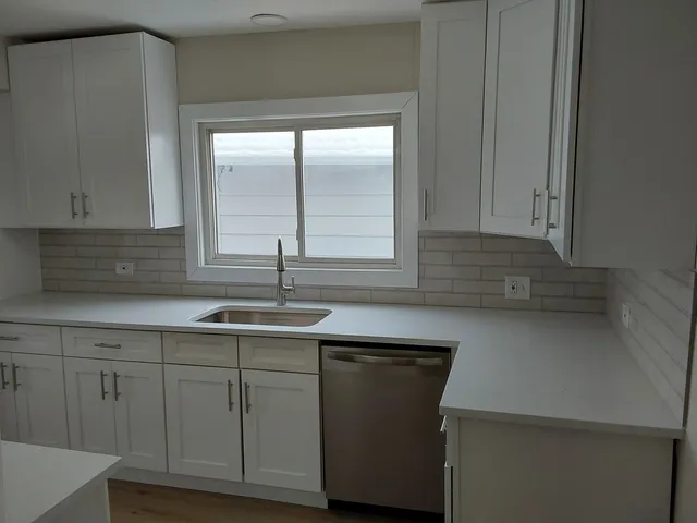 a kitchen with a sink and cabinets