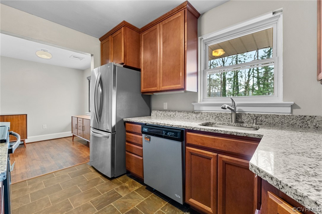 1221 Woodcroft Road Richmond, VA 23235 - Photo 14 of 42 a kitchen with stainless steel appliances granite countertop a sink stove and refrigerator