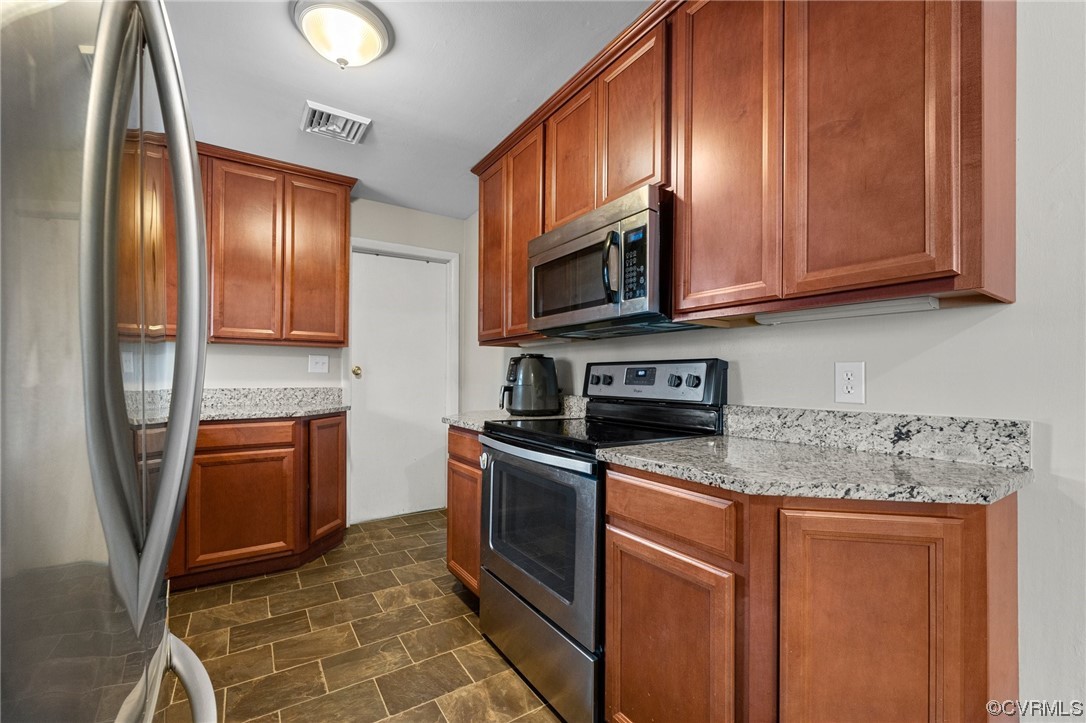 1221 Woodcroft Road Richmond, VA 23235 - Photo 15 of 42 a kitchen with stainless steel appliances granite countertop a refrigerator a stove top oven and sink
