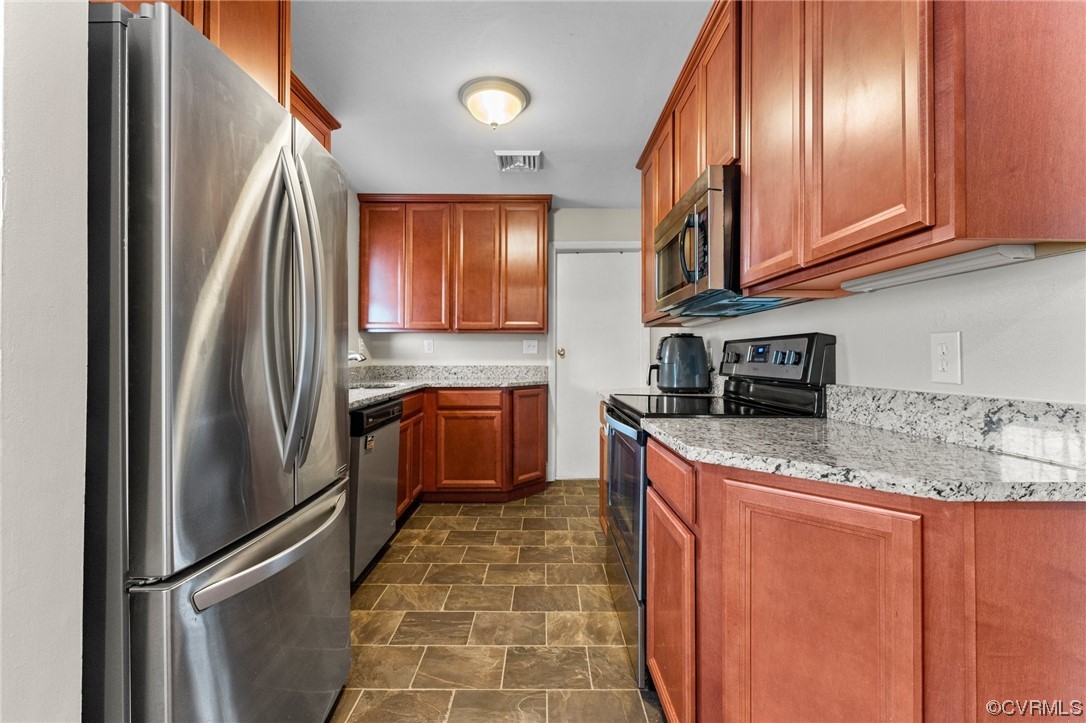 1221 Woodcroft Road Richmond, VA 23235 - Photo 16 of 42 a kitchen with stainless steel appliances granite countertop a refrigerator sink and stove