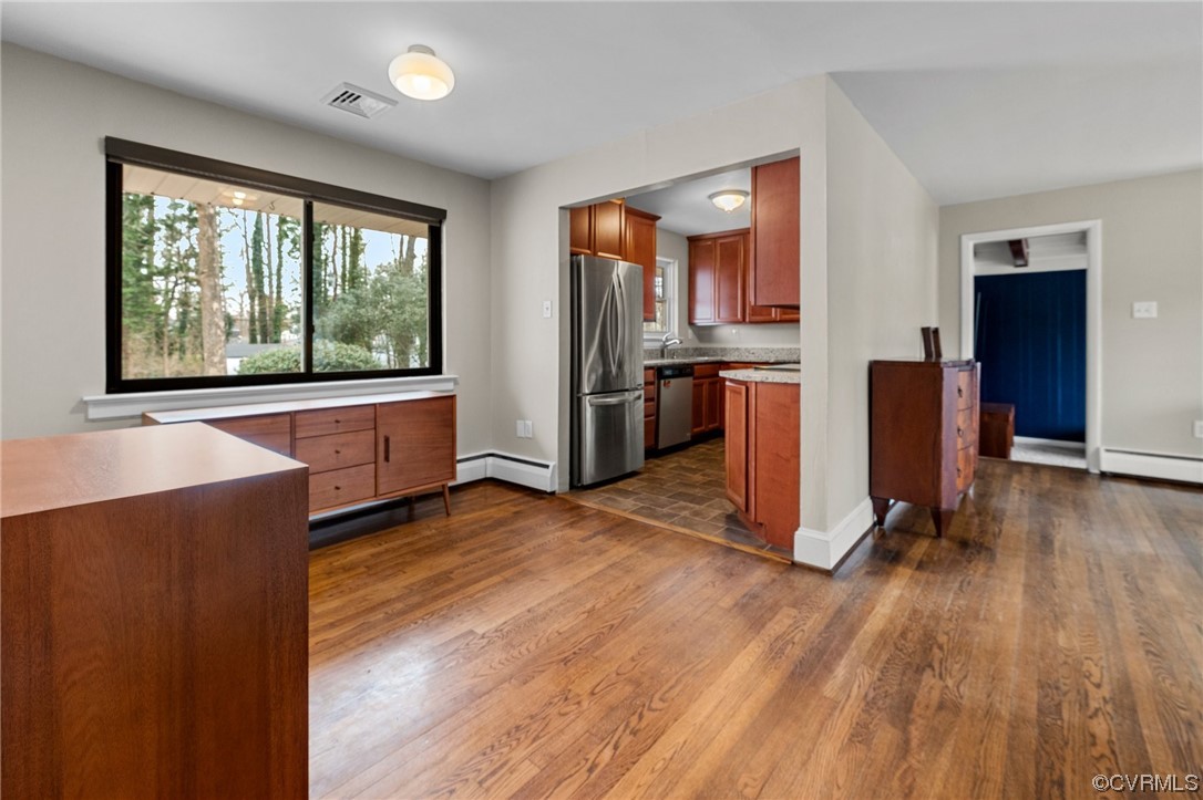 1221 Woodcroft Road Richmond, VA 23235 - Photo 17 of 42 a view of a kitchen with a stove cabinets and wooden floor