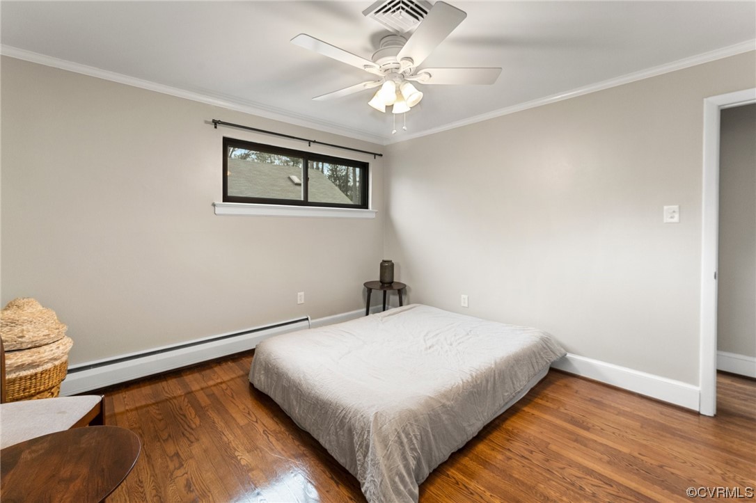 1221 Woodcroft Road Richmond, VA 23235 - Photo 25 of 42 a bedroom with a bed and a chandelier