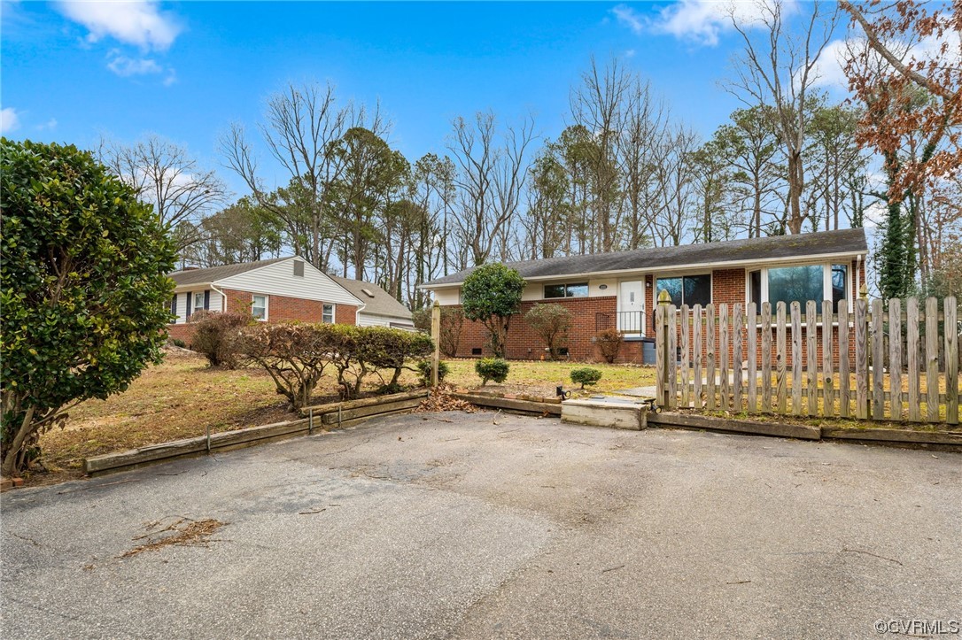1221 Woodcroft Road Richmond, VA 23235 - Photo 3 of 42 a view of a house with wooden fence
