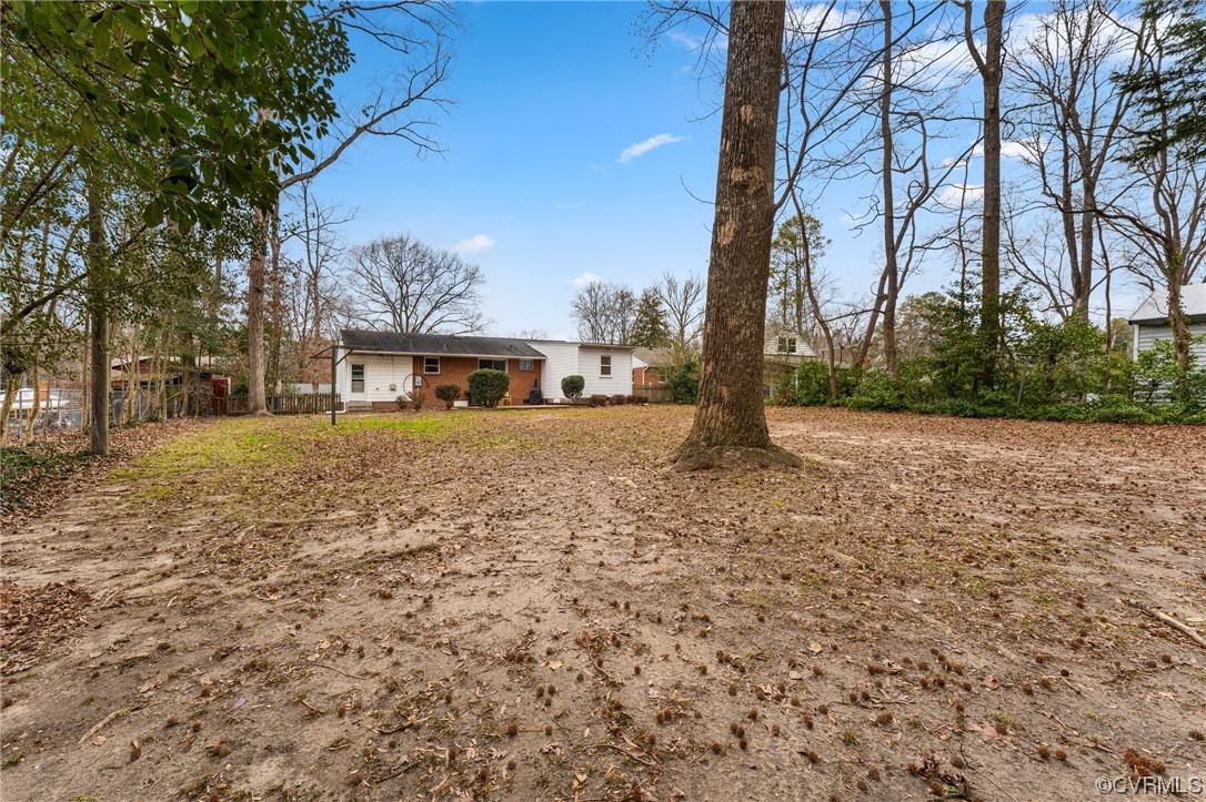 1221 Woodcroft Road Richmond, VA 23235 - Photo 38 of 42 a blue sign is sitting in front of a house