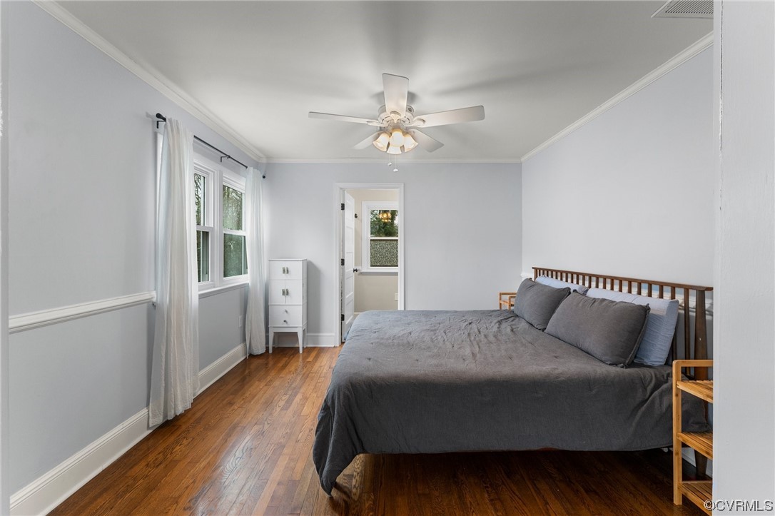 1221 Woodcroft Road Richmond, VA 23235 - Photo 39 of 42 a bedroom with a bed and wooden floor