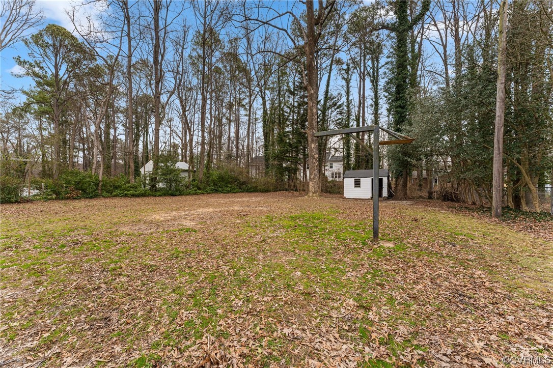 1221 Woodcroft Road Richmond, VA 23235 - Photo 42 of 42 a backyard of a house with lots of green space
