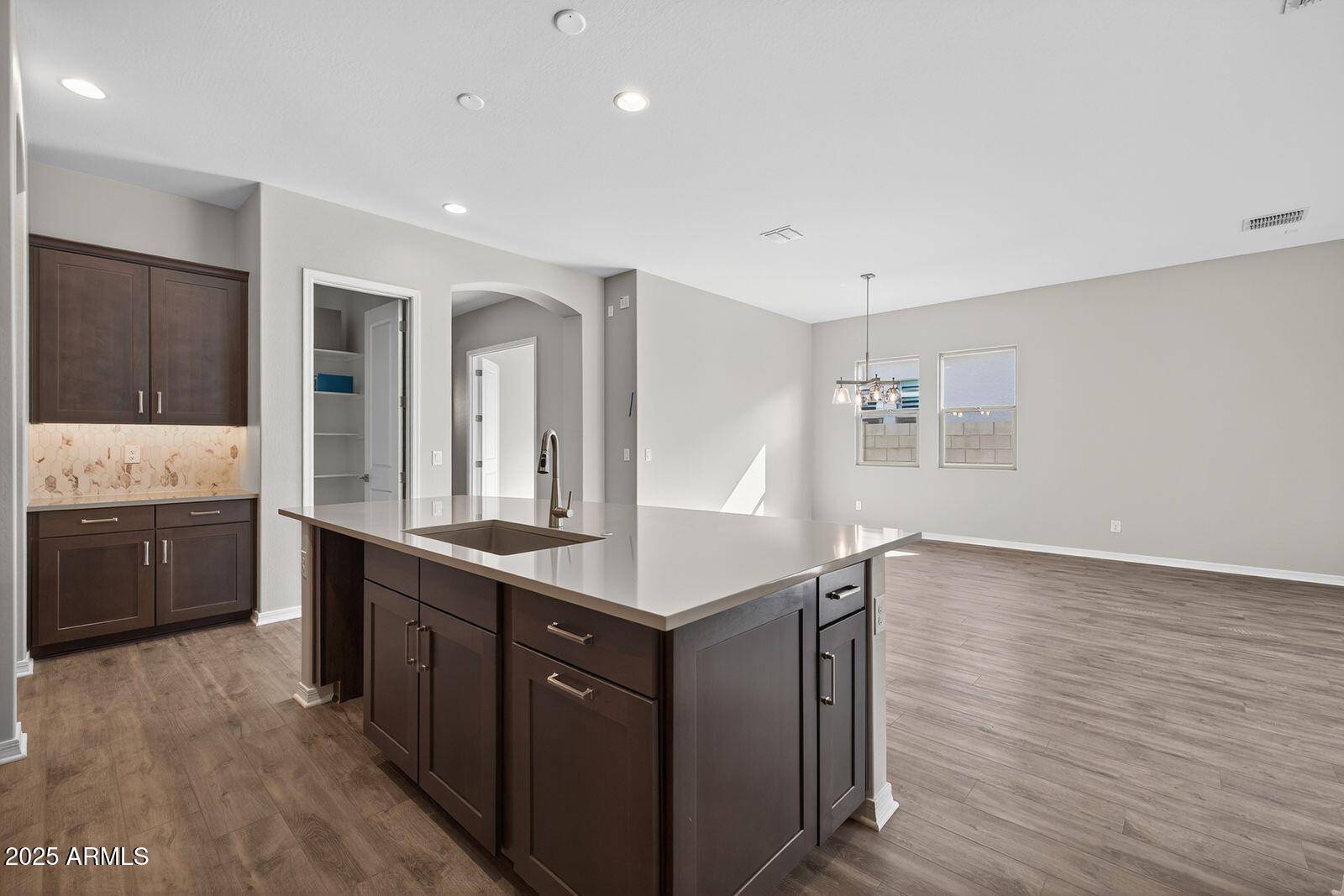 3191 West Santa Rosa Road San Tan Valley, AZ 85144 - Photo 14 of 52 a kitchen with granite countertop a stove and cabinets
