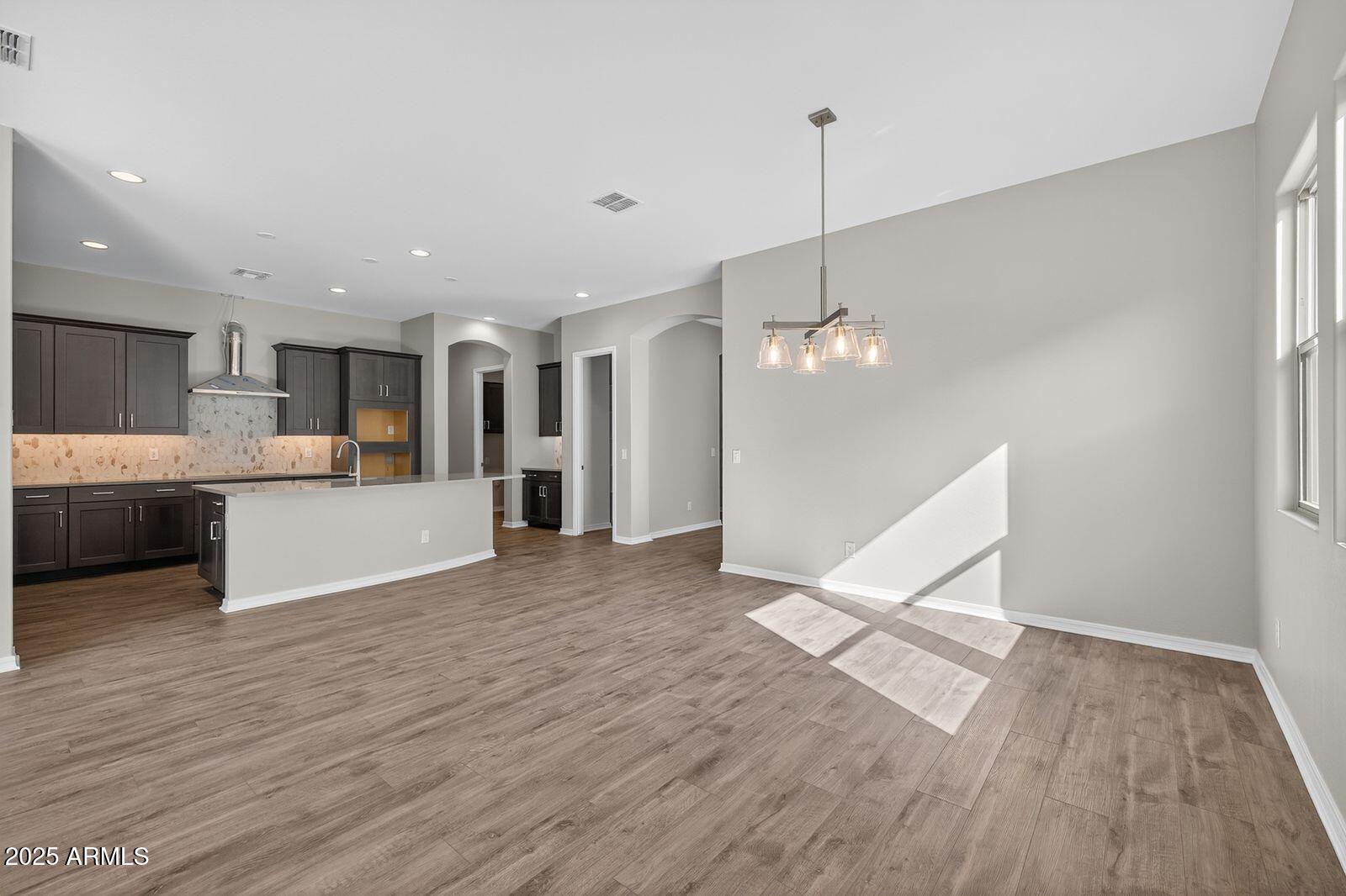 3191 West Santa Rosa Road San Tan Valley, AZ 85144 - Photo 19 of 52 a view of a kitchen with wooden floor and a window
