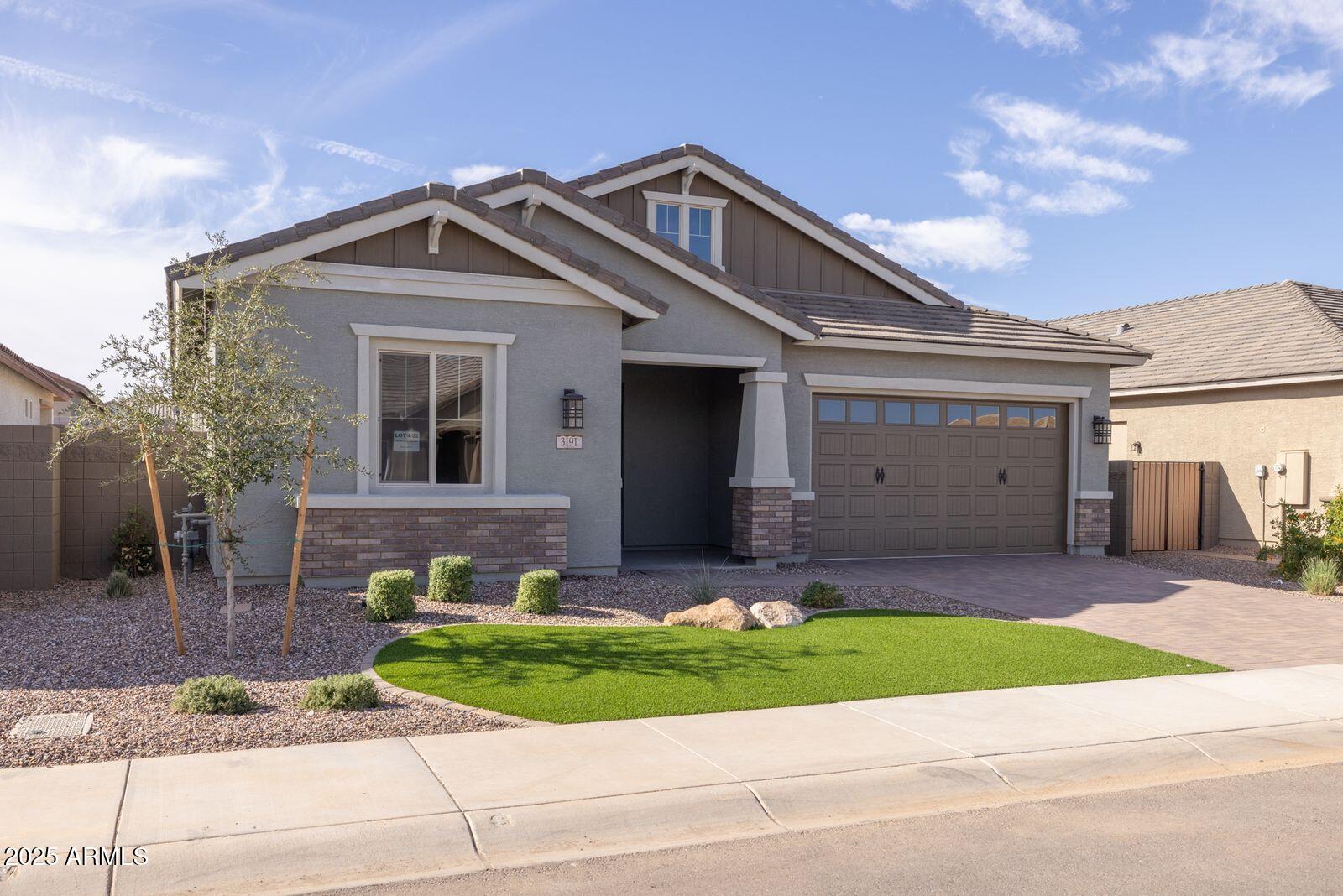 3191 West Santa Rosa Road San Tan Valley, AZ 85144 - Photo 2 of 52 a front view of a house with a yard and garage