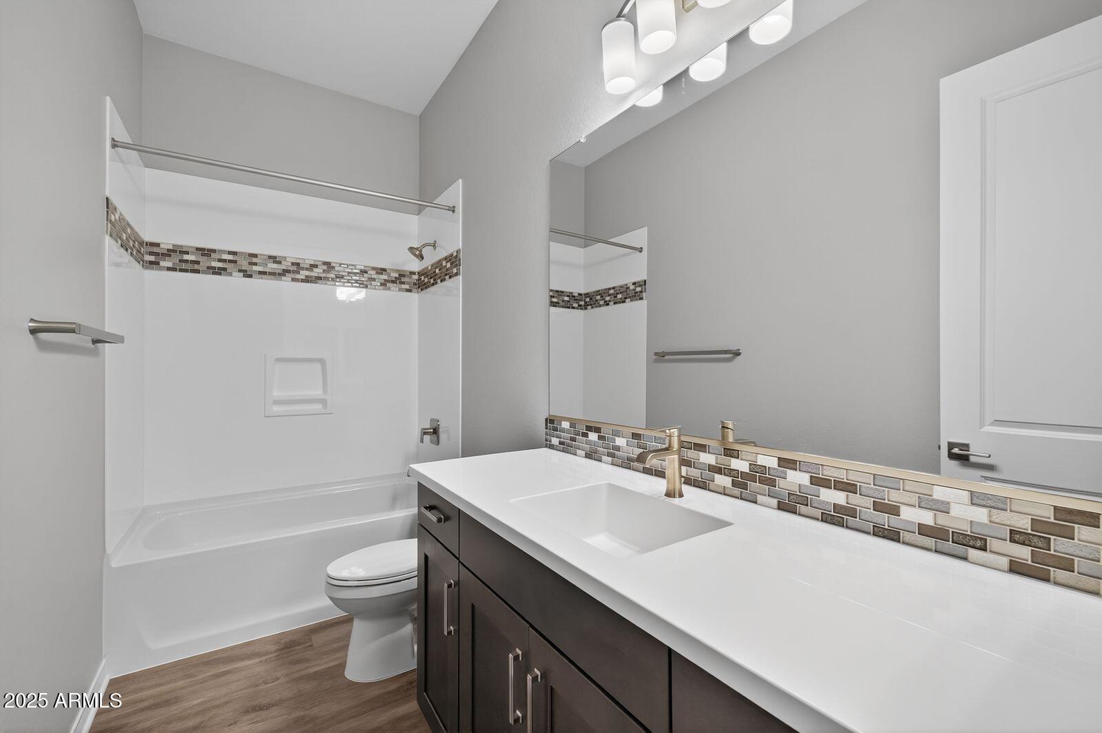 3191 West Santa Rosa Road San Tan Valley, AZ 85144 - Photo 28 of 52 a bathroom with a sink a toilet a mirror and shower