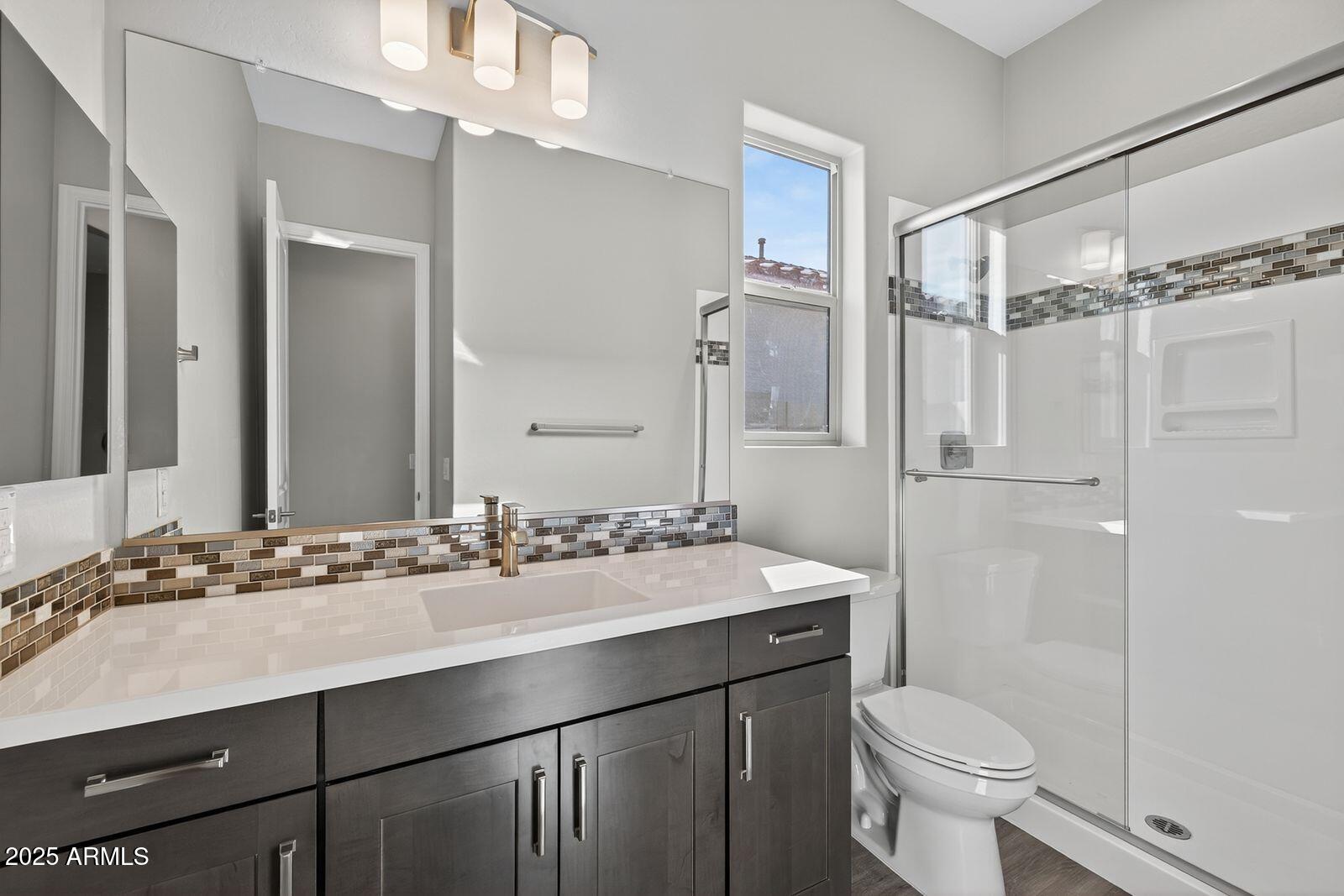 3191 West Santa Rosa Road San Tan Valley, AZ 85144 - Photo 32 of 52 a bathroom with a sink vanity mirror and toilet