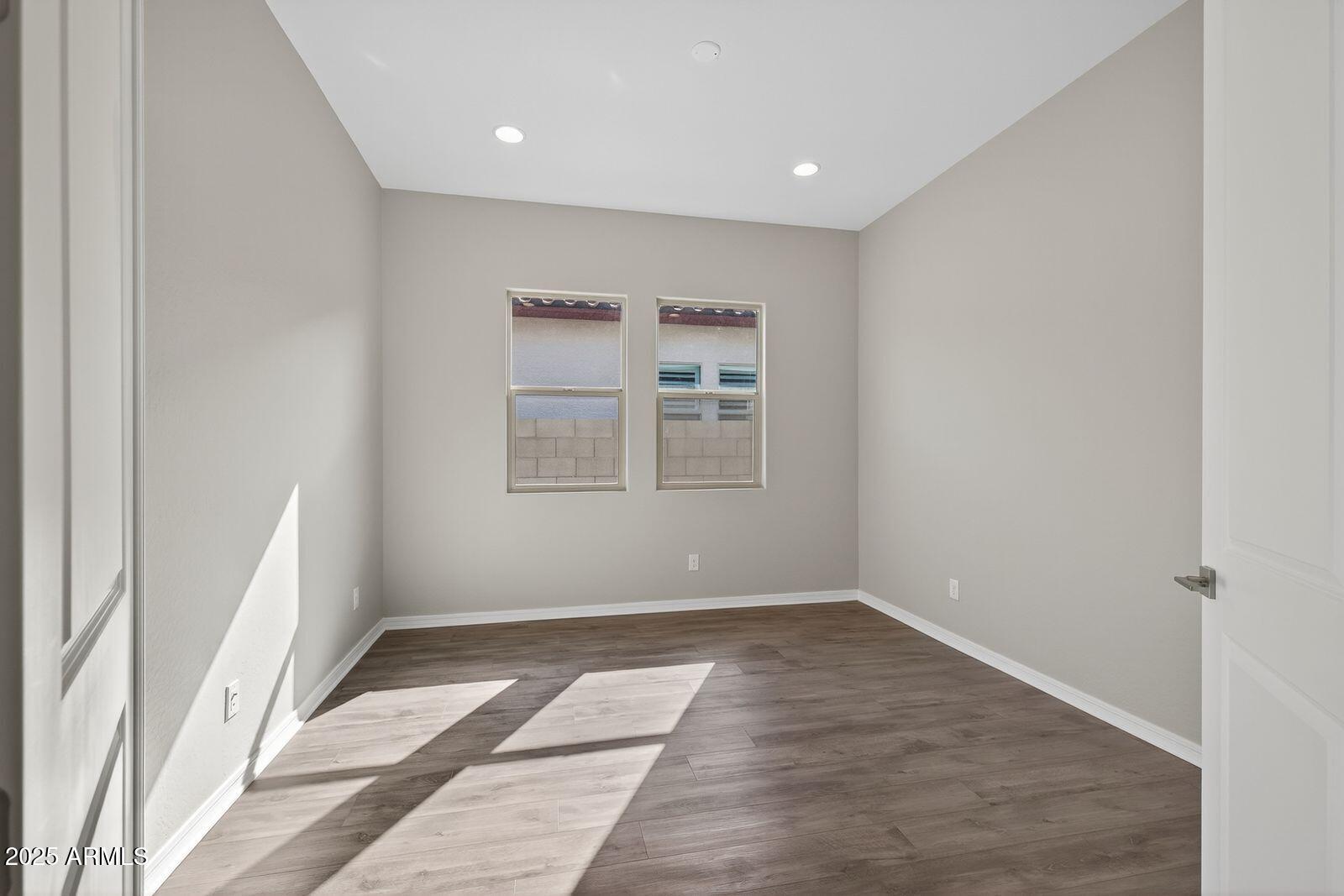 3191 West Santa Rosa Road San Tan Valley, AZ 85144 - Photo 34 of 52 an empty room with wooden floor and windows
