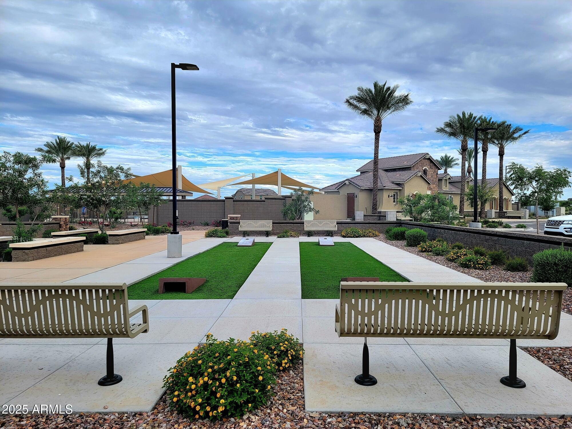 3191 West Santa Rosa Road San Tan Valley, AZ 85144 - Photo 48 of 52 a view of a street with a bench and wooden fence