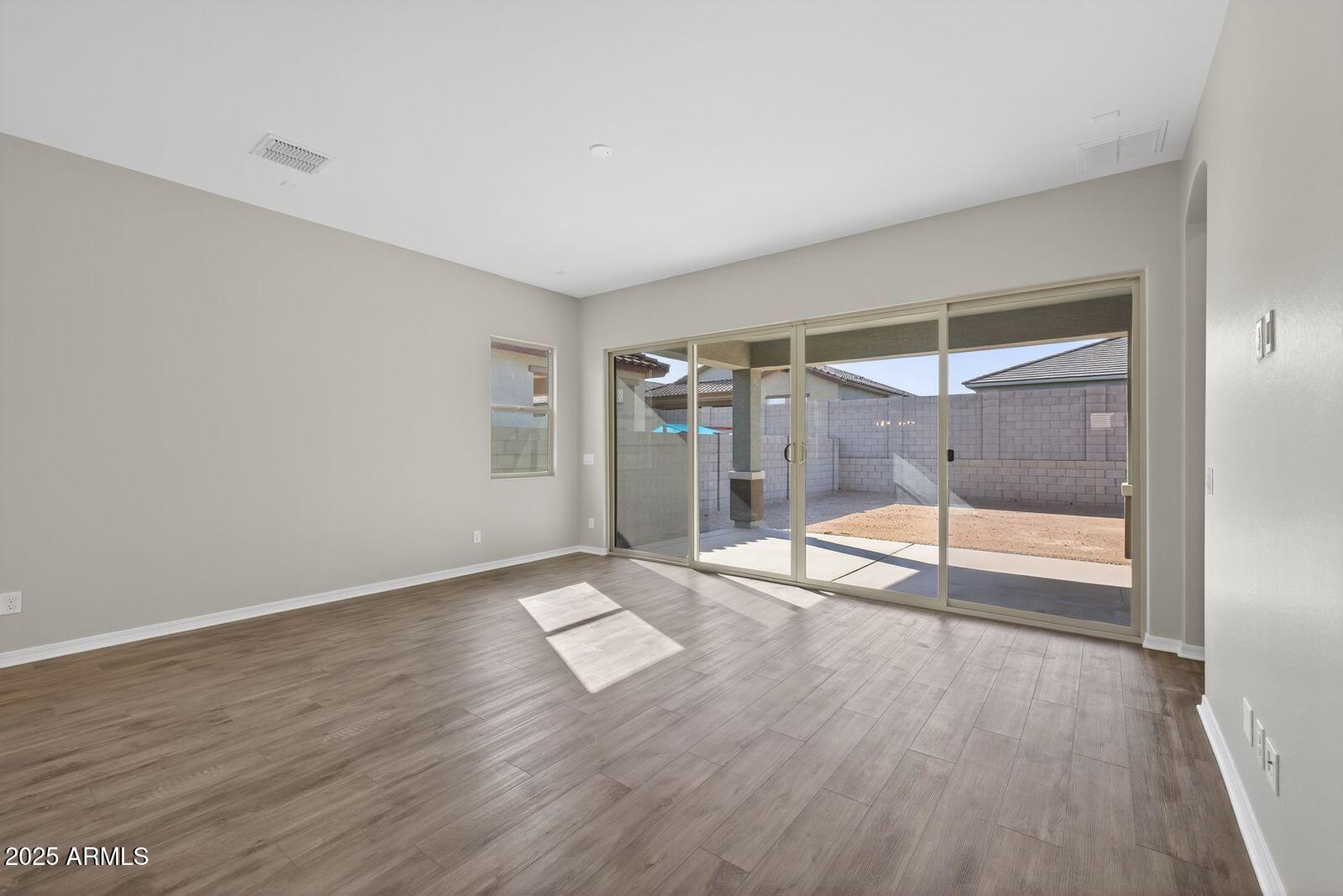 3191 West Santa Rosa Road San Tan Valley, AZ 85144 - Photo 5 of 52 wooden floor in an empty room with a window