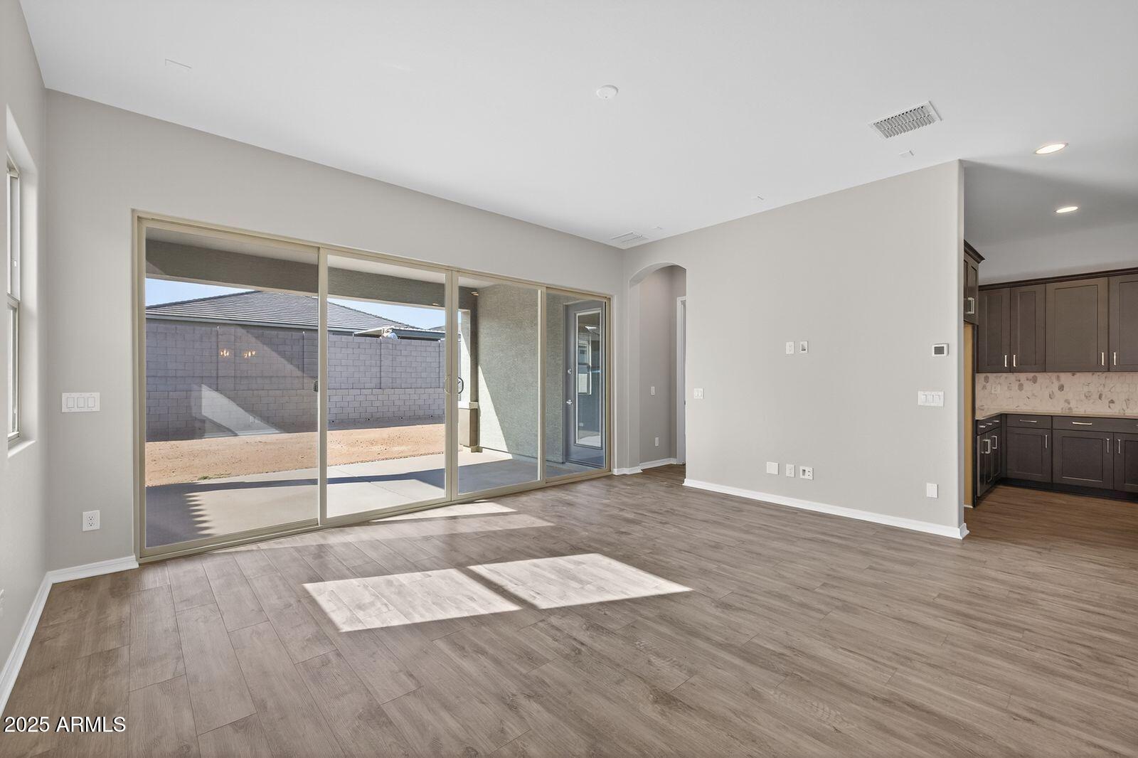 3191 West Santa Rosa Road San Tan Valley, AZ 85144 - Photo 8 of 52 a view of empty room with wooden floor and fan