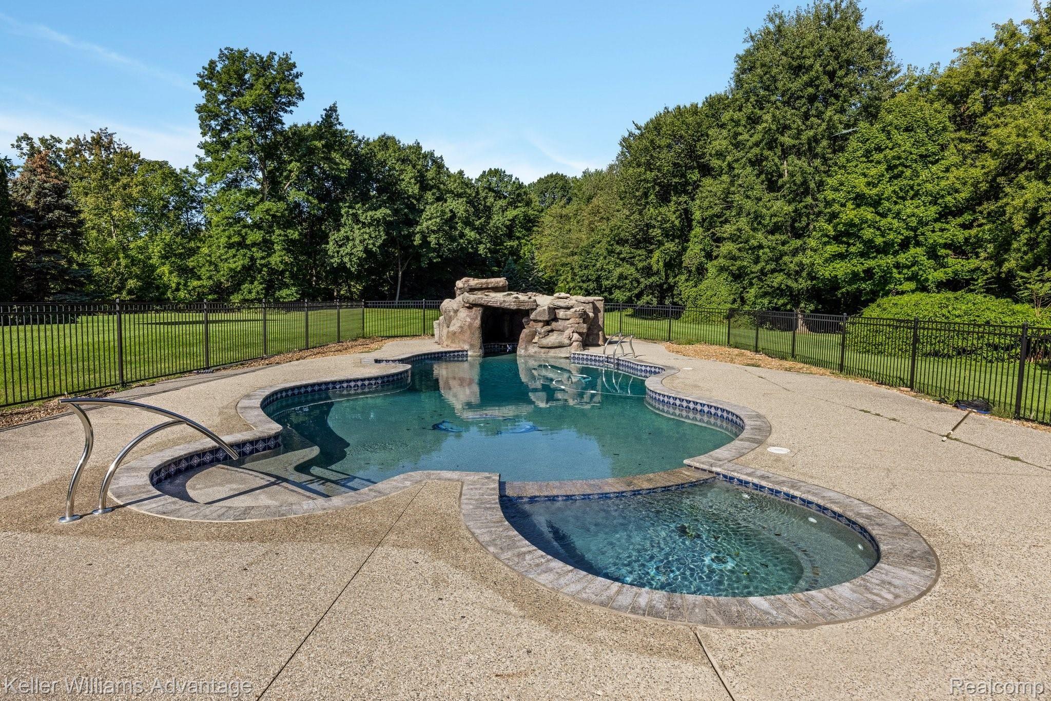 38125 Hayes Road Sterling Heights, MI 48313 - Photo 54 of 83 Securely gated oasis pool w spa and grotto waterfall cave.