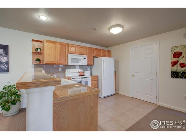 a kitchen with refrigerator and cabinets