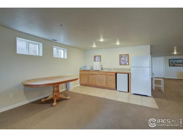 a dining hall with a large dining table and a large window