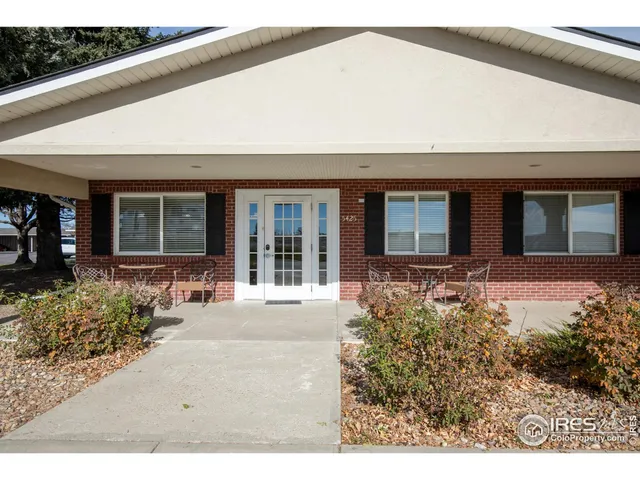 a kitchen with a refrigerator and white cabinets