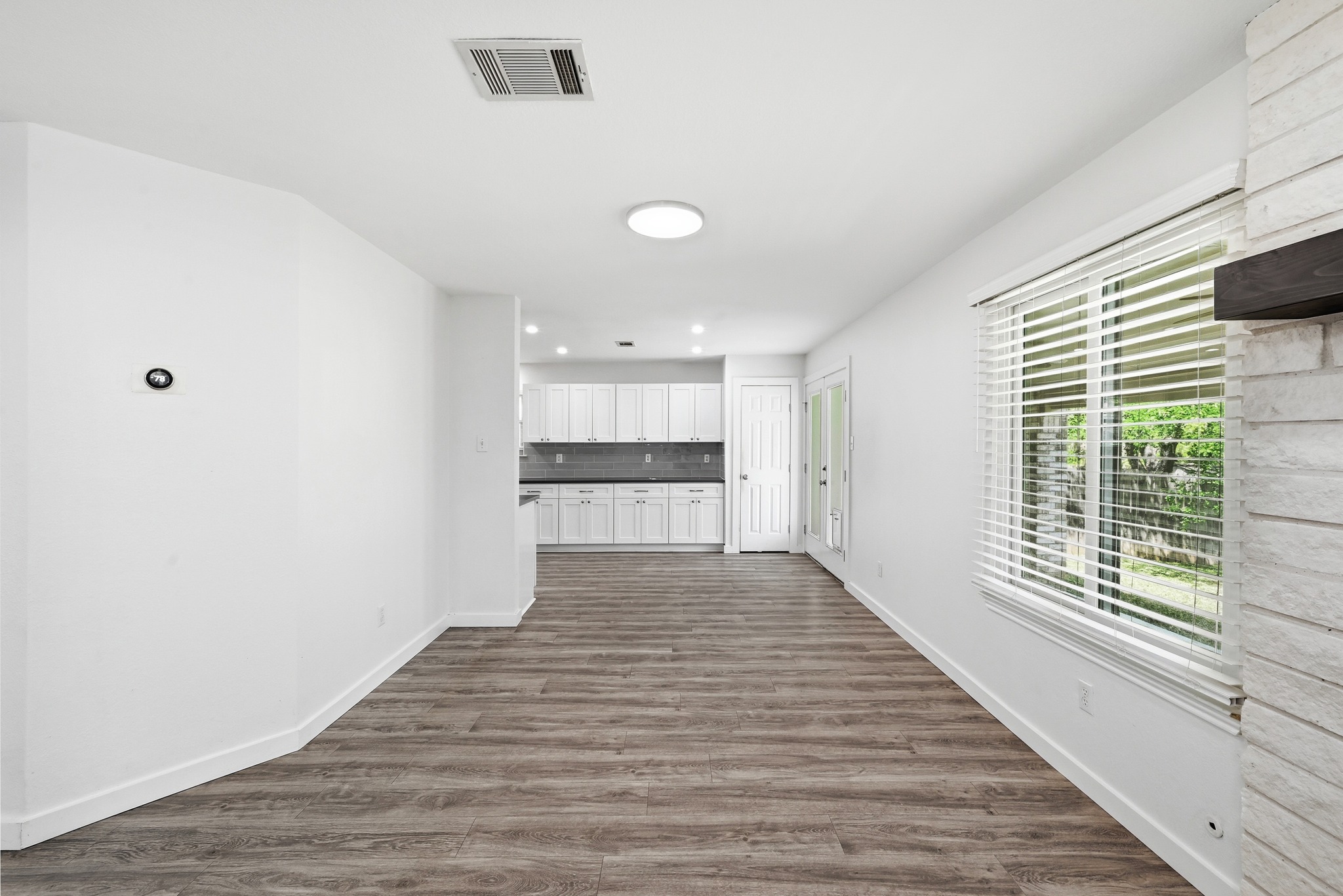 5812 Kayview Drive Austin, TX 78749 - Photo 13 of 31 a view of an empty room with wooden floor and a window