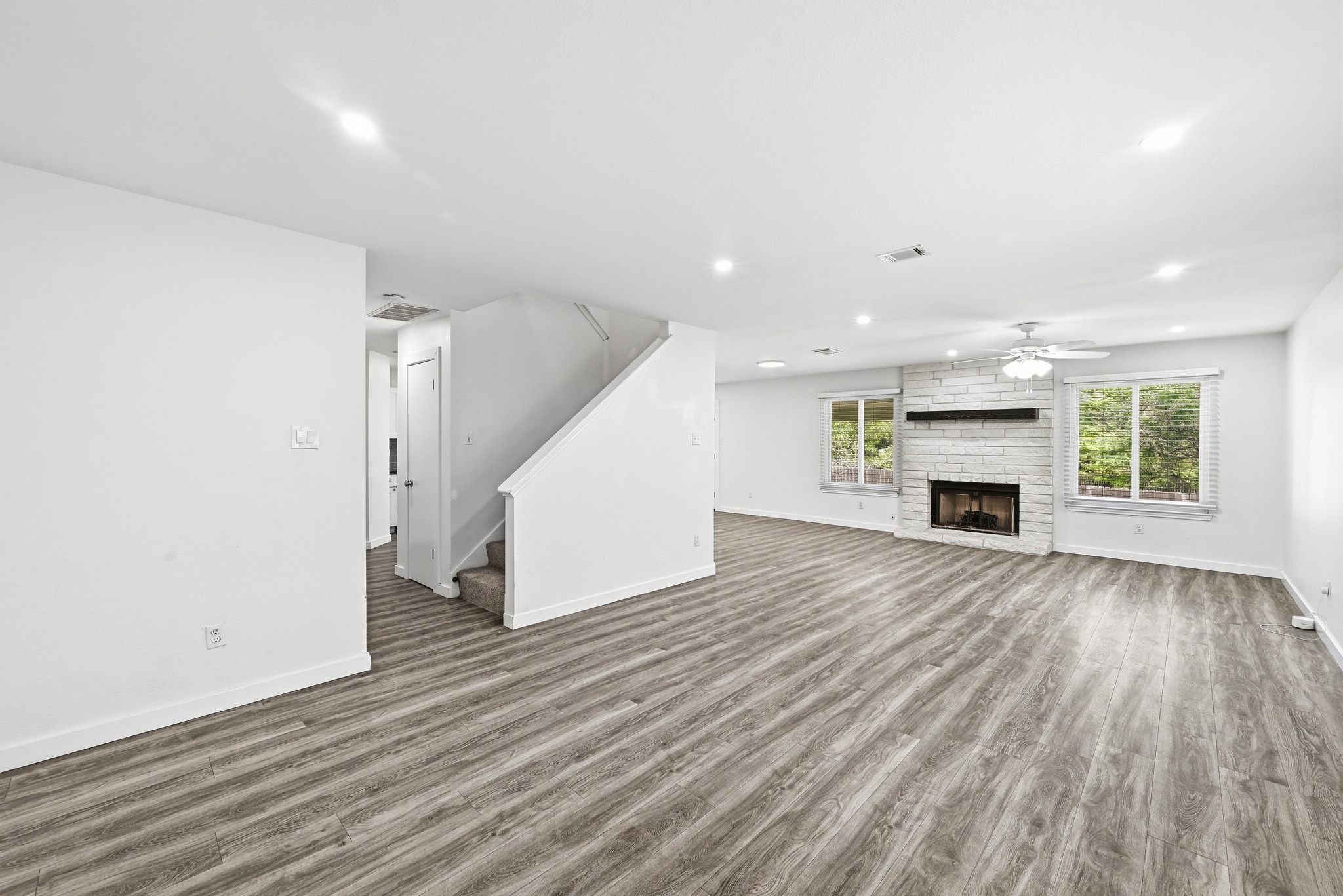 5812 Kayview Drive Austin, TX 78749 - Photo 15 of 31 an empty room with wooden floor and fireplace