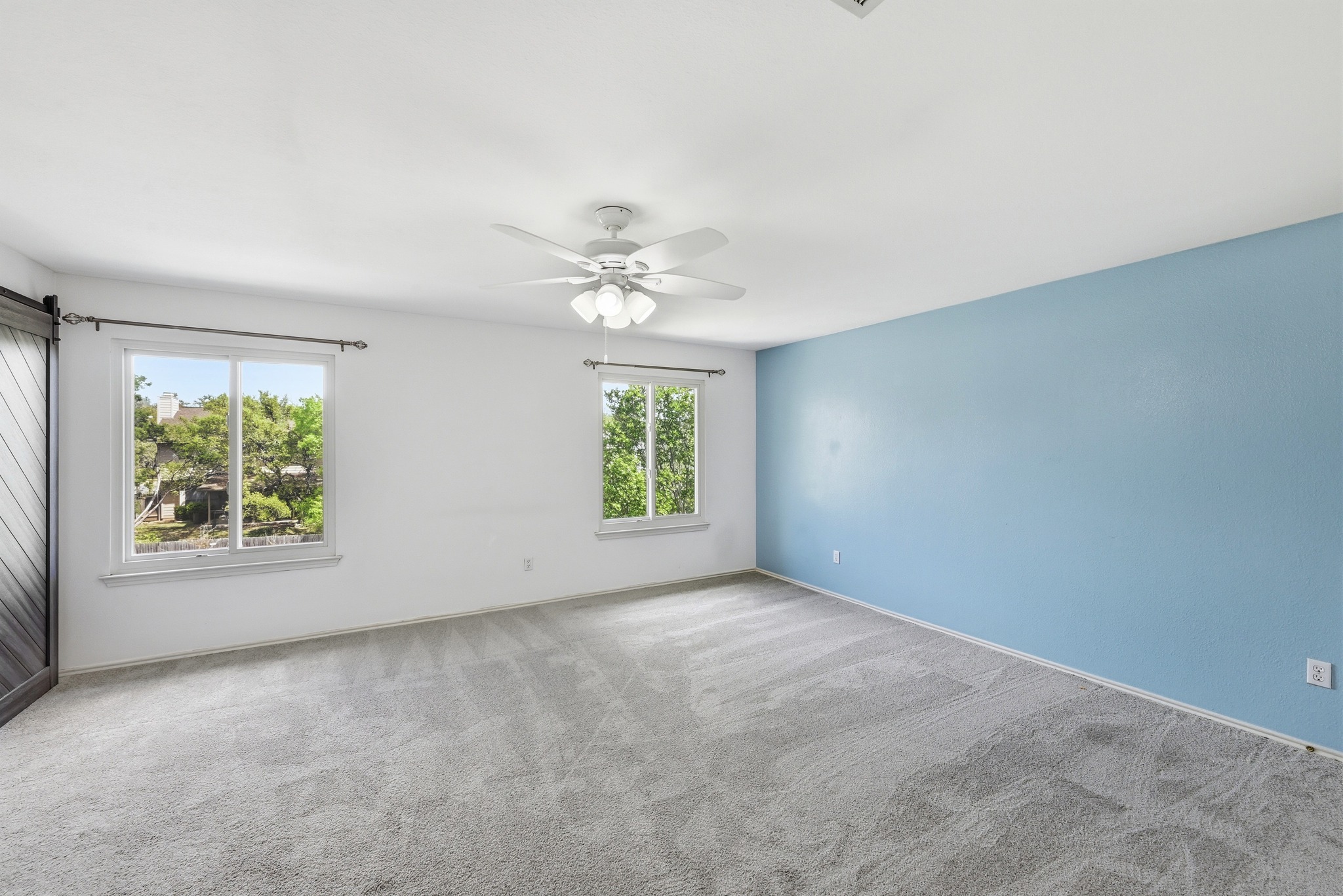 5812 Kayview Drive Austin, TX 78749 - Photo 21 of 31 an empty room with windows and chandelier fan