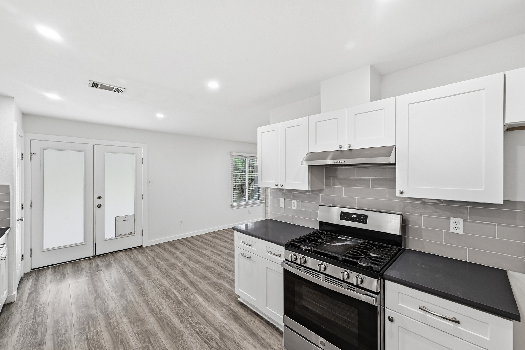 5812 Kayview Drive Austin, TX 78749 - Photo 7 of 31 a kitchen with granite countertop a stove and a sink