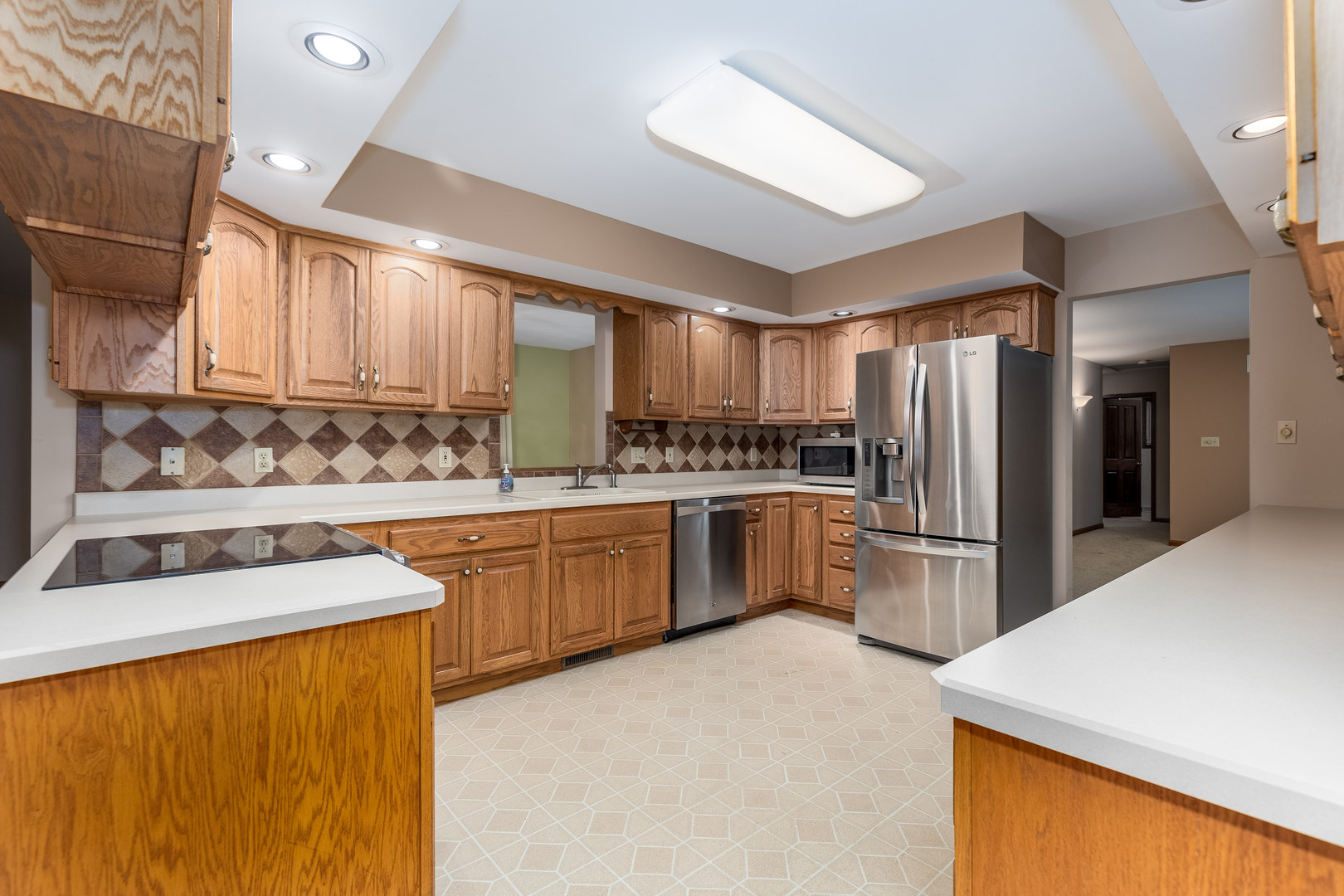 145 Porter Avenue Grand Ridge, IL 61325 - Photo 8 of 32 a kitchen with refrigerator a stove a sink and a microwave