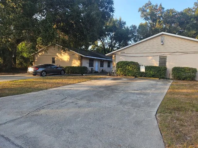 a view of a house with a yard and garage