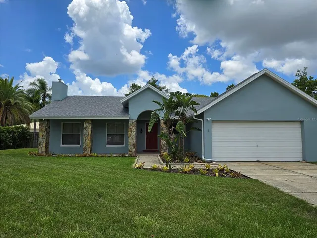 a front view of house with yard and garage