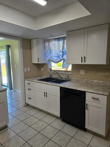 a kitchen with stainless steel appliances granite countertop a sink and a stove top oven