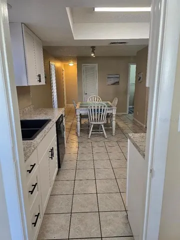 a kitchen with a sink a stove and a refrigerator