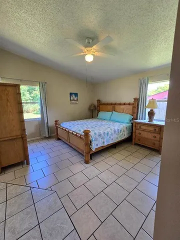 a bedroom with a bed and a view of kitchen