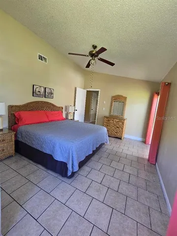 a bedroom with a bed and a lamp