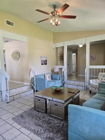 a living room with furniture and a chandelier