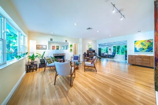 a living room with furniture and a floor to ceiling window