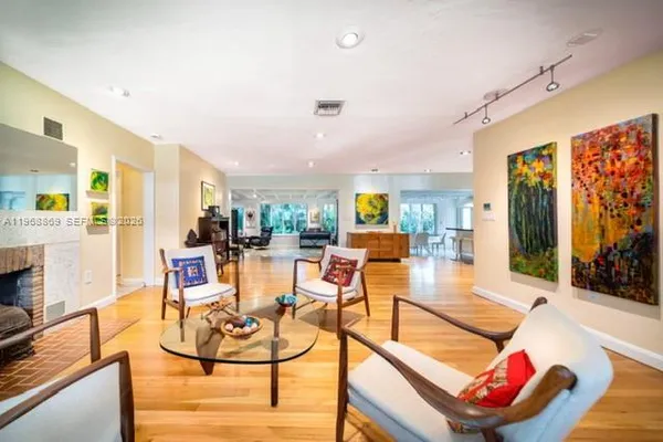 a living room with furniture and wooden floor