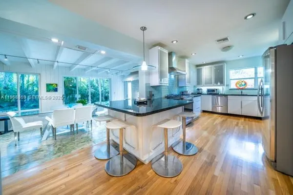 a large kitchen with stainless steel appliances granite countertop a stove and a sink