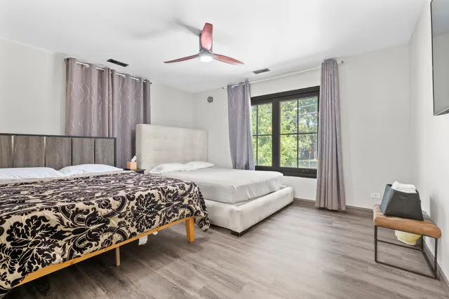 a bedroom with a bed and a chair