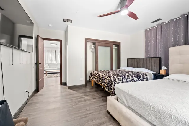 a bedroom with two beds and a chandelier