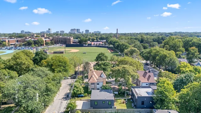 an aerial view of a house with a garden and lake view